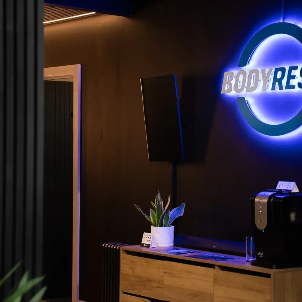 Body Reset reception area at Court De Padel with illuminated wall logo